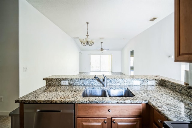 kitchen featuring ceiling fan with notable chandelier, light stone countertops, stainless steel dishwasher, and sink