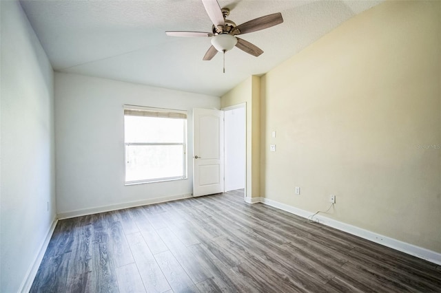 empty room featuring hardwood / wood-style flooring, a textured ceiling, ceiling fan, and vaulted ceiling