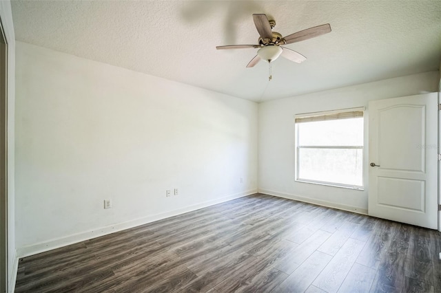 empty room with dark hardwood / wood-style flooring, a textured ceiling, and ceiling fan