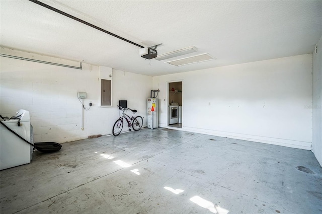 garage with a garage door opener, water heater, washer / clothes dryer, and electric panel