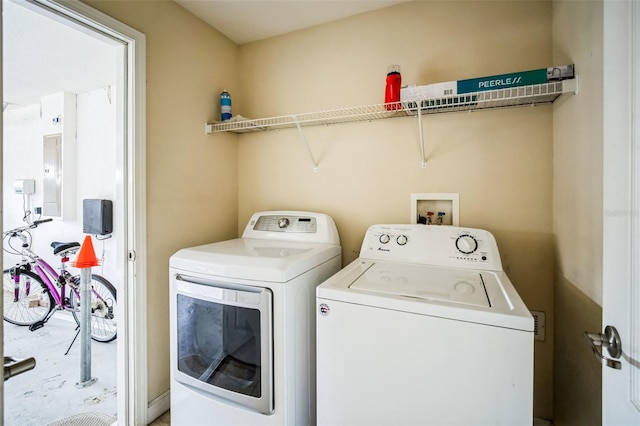 laundry room with washer and dryer and electric panel