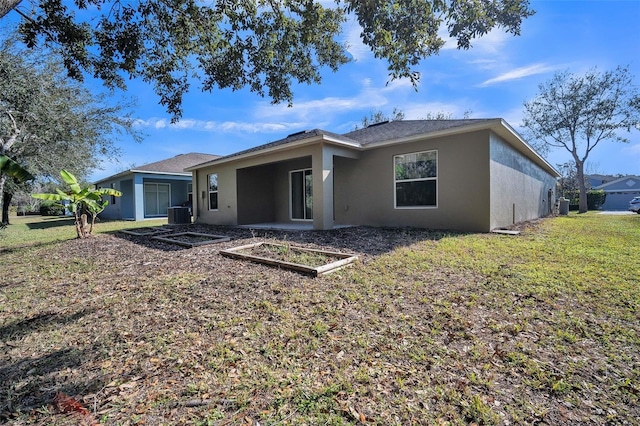 rear view of property with cooling unit and a lawn