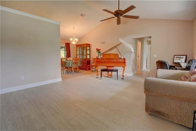 living room featuring light wood-type flooring, lofted ceiling, and ceiling fan with notable chandelier