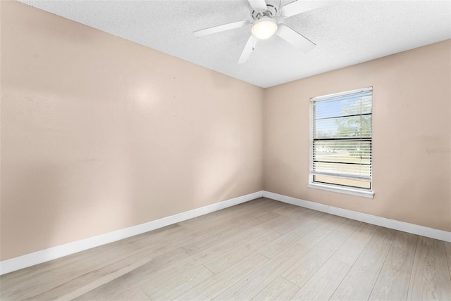 spare room with light hardwood / wood-style floors, a textured ceiling, and ceiling fan