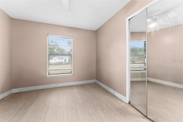 spare room with ceiling fan and light hardwood / wood-style flooring