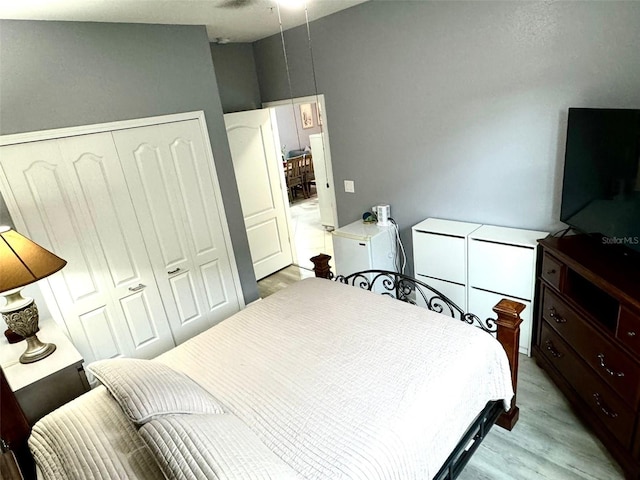 bedroom with light wood-type flooring and a closet