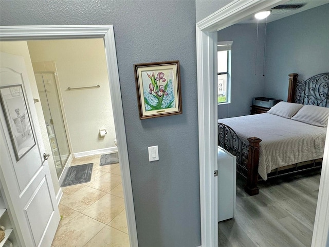 bedroom featuring ceiling fan and connected bathroom