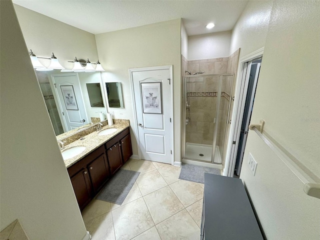 bathroom with vanity, tile patterned flooring, and a shower with door