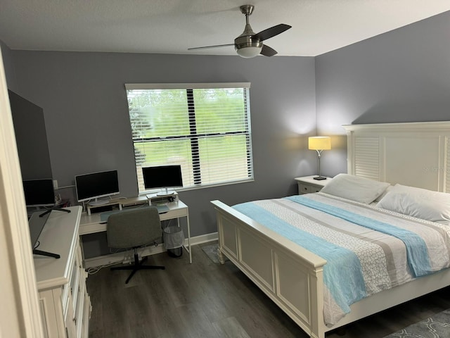 bedroom with ceiling fan and dark hardwood / wood-style floors