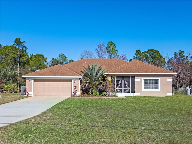 single story home with a garage and a front lawn