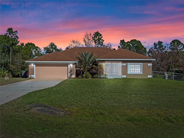 ranch-style home with a lawn and a garage