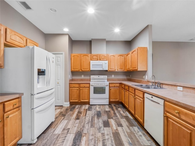 kitchen with sink, white appliances, and dark wood-type flooring