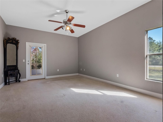 unfurnished living room featuring ceiling fan and light carpet