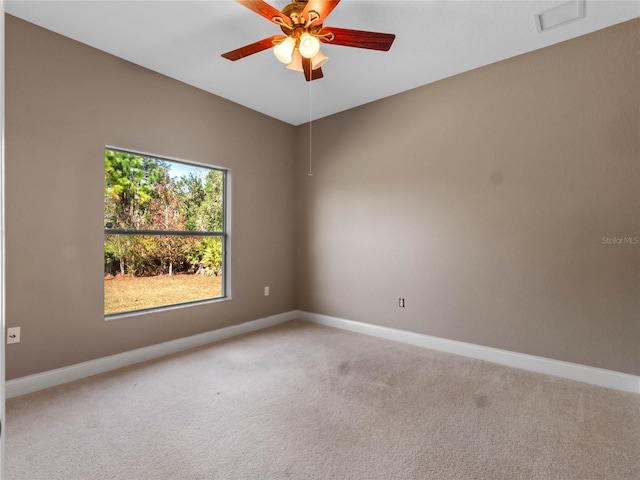 spare room featuring ceiling fan and carpet flooring