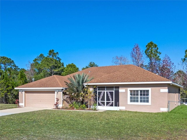 ranch-style home featuring a garage and a front yard