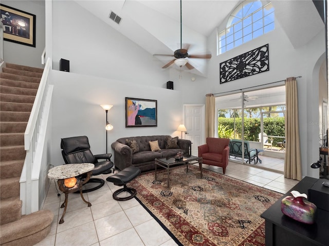 living area featuring stairway, ceiling fan, light tile patterned floors, and visible vents