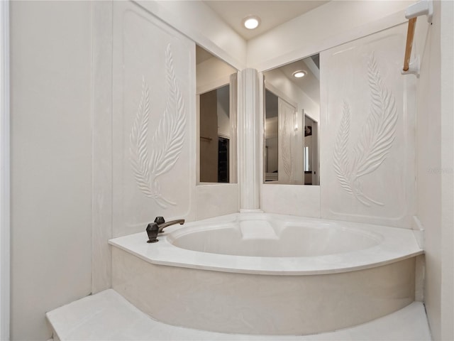 bathroom with a bath and recessed lighting