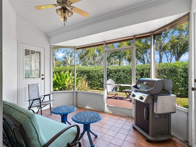 sunroom / solarium with lofted ceiling and ceiling fan