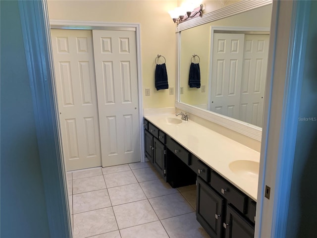 full bath featuring double vanity, a sink, and tile patterned floors