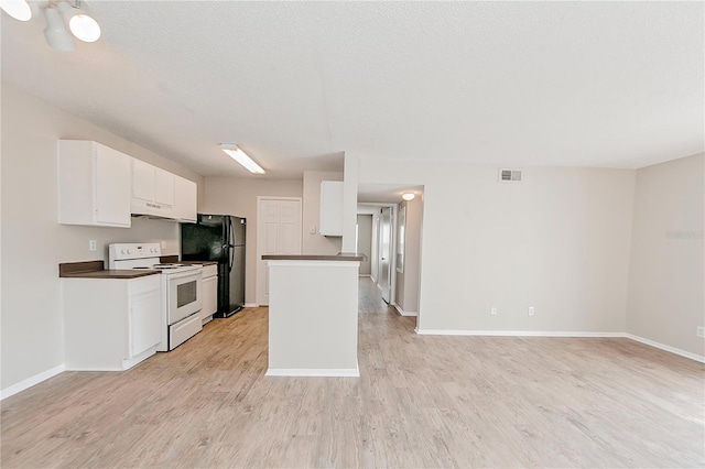 kitchen featuring a textured ceiling, electric stove, black fridge, light wood-type flooring, and white cabinets