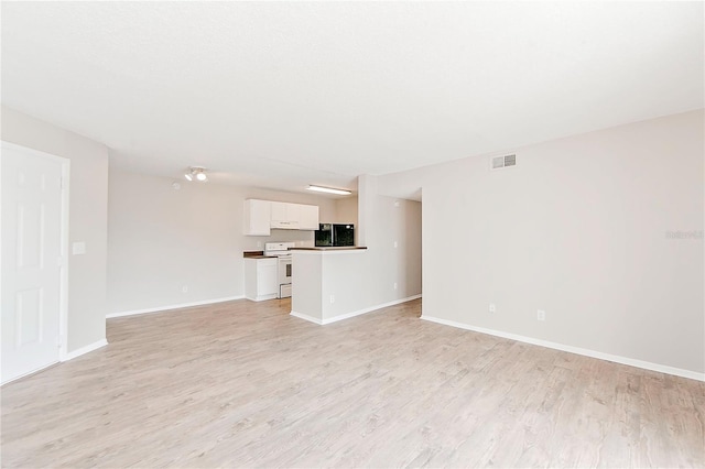 unfurnished living room featuring light wood-type flooring