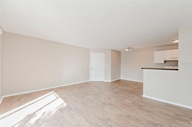 unfurnished living room with light wood-type flooring