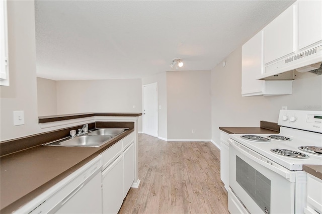 kitchen featuring white appliances, white cabinets, light hardwood / wood-style flooring, and sink