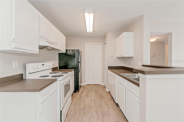 kitchen with white appliances, light hardwood / wood-style floors, white cabinets, and a textured ceiling