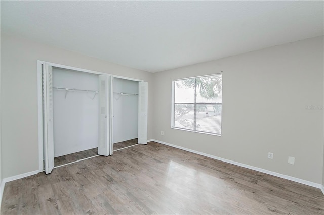 unfurnished bedroom featuring hardwood / wood-style flooring