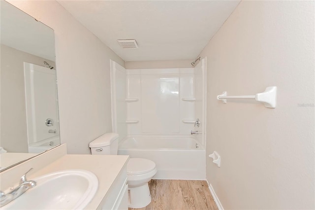 full bathroom with toilet, vanity, hardwood / wood-style flooring, and  shower combination