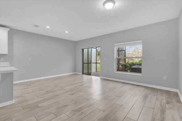 spare room with light hardwood / wood-style floors