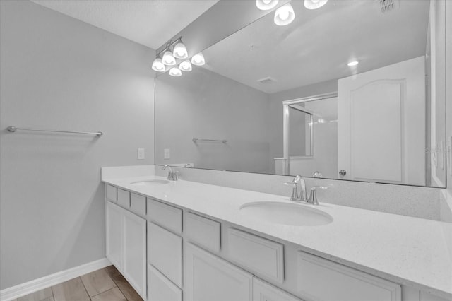 bathroom with an enclosed shower and vanity