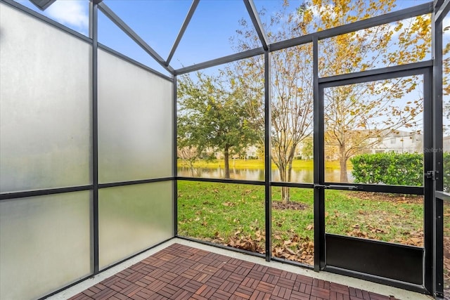 unfurnished sunroom with a water view