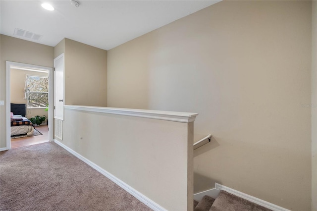 hallway featuring carpet flooring