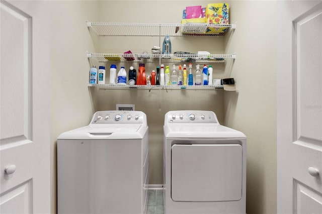 clothes washing area featuring washer and dryer