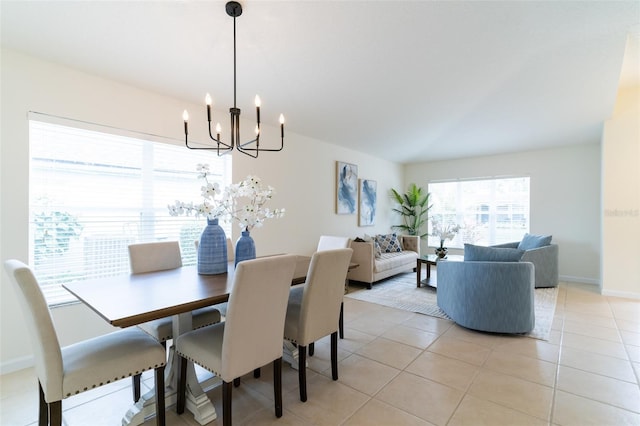 tiled dining area featuring a chandelier