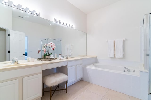 bathroom featuring vanity, tile patterned flooring, and plus walk in shower