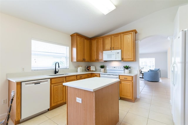 kitchen with sink, a center island, vaulted ceiling, white appliances, and light tile patterned floors