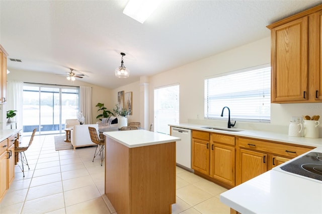 kitchen featuring dishwasher, hanging light fixtures, ceiling fan, a kitchen island, and sink