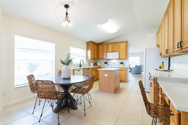 kitchen featuring white appliances, pendant lighting, a center island, lofted ceiling, and sink