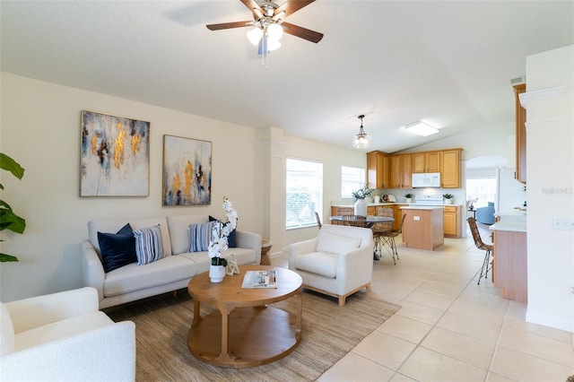 tiled living room with lofted ceiling and ceiling fan