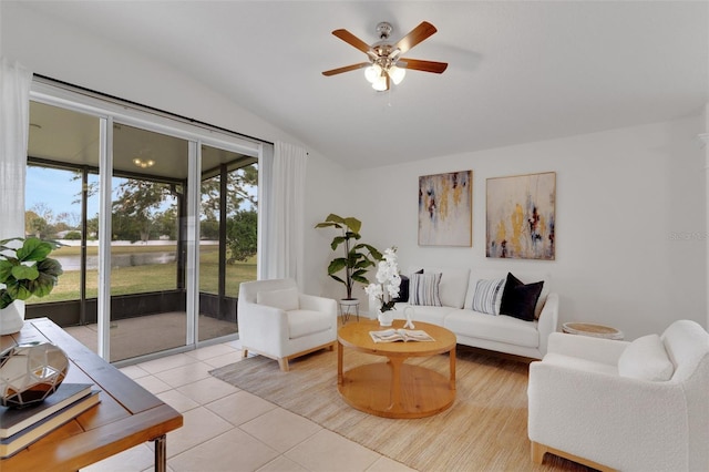 living room featuring ceiling fan, light tile patterned flooring, and lofted ceiling