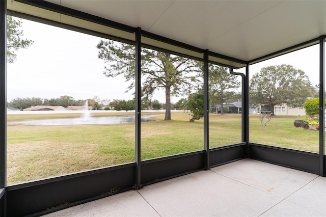 unfurnished sunroom featuring a water view