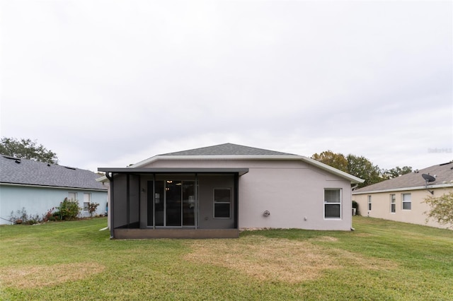 rear view of house with a lawn