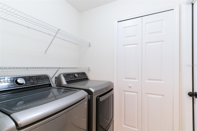 clothes washing area with washer and dryer