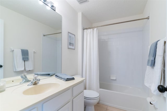 full bathroom featuring shower / tub combo, toilet, vanity, tile patterned floors, and a textured ceiling