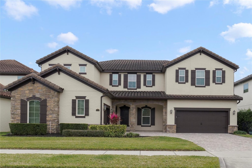 view of front of house featuring a garage and a front lawn