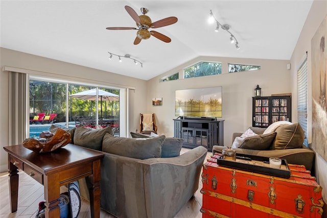 living room with ceiling fan, vaulted ceiling, and hardwood / wood-style floors