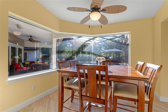 dining space with ceiling fan and hardwood / wood-style flooring