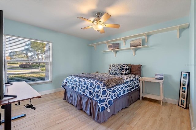 bedroom with ceiling fan and light wood-type flooring